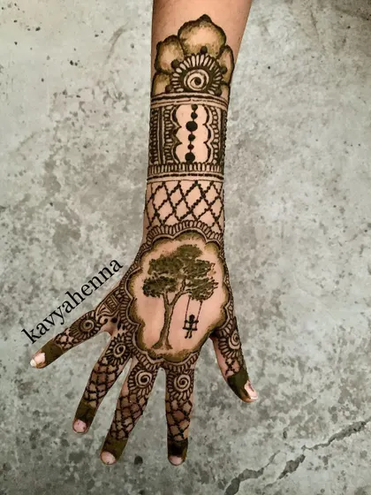 This design tells a small story, featuring a person on a jhula (swing) set within a detailed pattern. It’s an example of how I can incorporate personal and narrative elements into a party henna design.