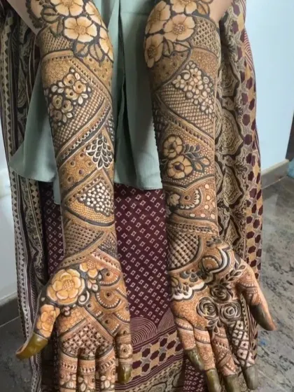 Another beautiful example of a full-arm floral mehendi, with a mix of roses and other blossoms creating a garden on the arms.