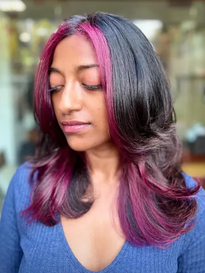 The purple peekaboo highlights look stunning from every angle, adding a pop of color that's visible with movement.