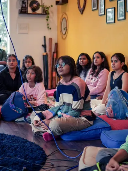 Students listening intently during a vocal workshop. We create a safe space for singers to learn, experiment, and find their voice.