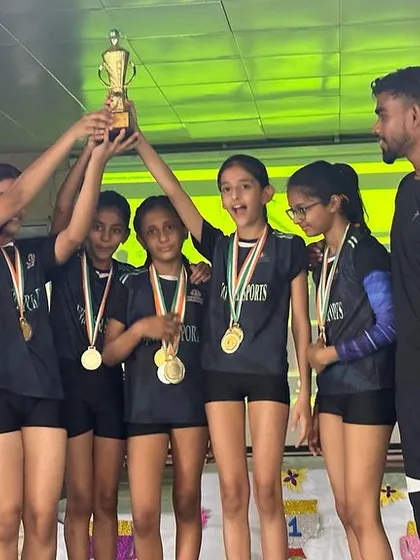 Hoisting the trophy high. The joy of victory after months of hard work and dedication.