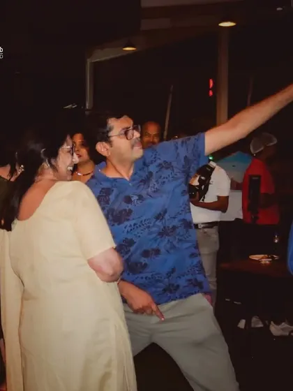 Adults letting loose and dancing at a birthday party. Age is just a number when you're having fun.
