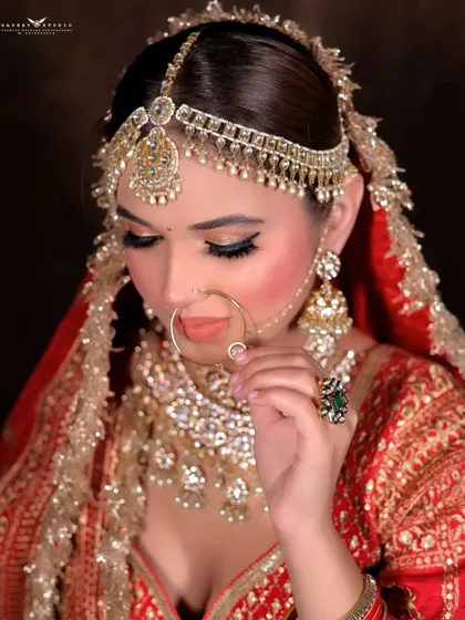 A delicate pose where the bride touches her ring, highlighting her bridal jewellery and the soft makeup look.