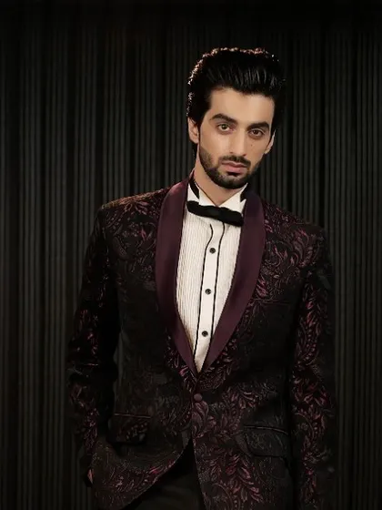 A closer portrait in the burgundy patterned tuxedo. The satin shawl collar provides a beautiful contrast to the rich texture of the jacket.
