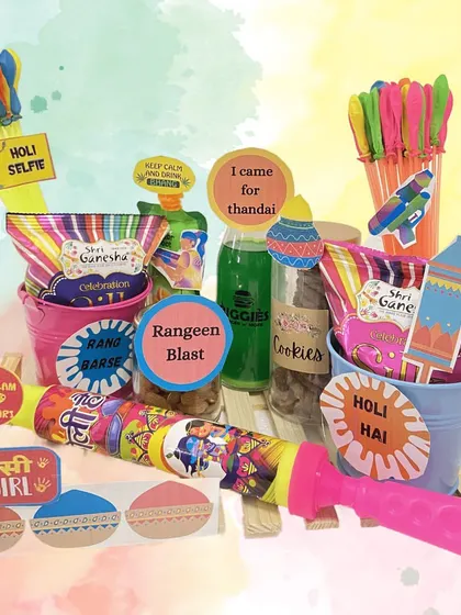 A fun and colorful Holi hamper for kids and adults alike. It includes buckets filled with treats, water guns, and other festive essentials.