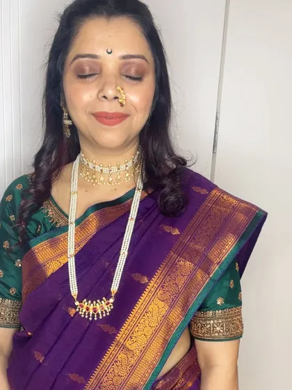 My client Anita celebrating Gauri Ganpati. I created this classic look with a pearl choker, a traditional nath, and makeup that complements her beautiful purple Paithani saree.