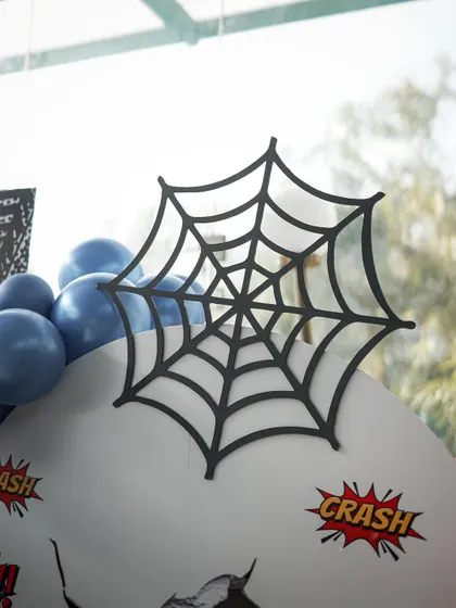 A close-up of the spider web prop, a simple but effective detail that instantly signals the Spider-Man element of this superhero theme.