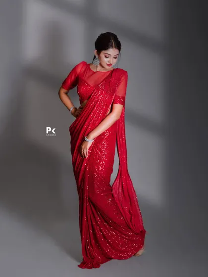 Another shot of the red sequin saree, showcasing its glamorous and eye-catching appeal.