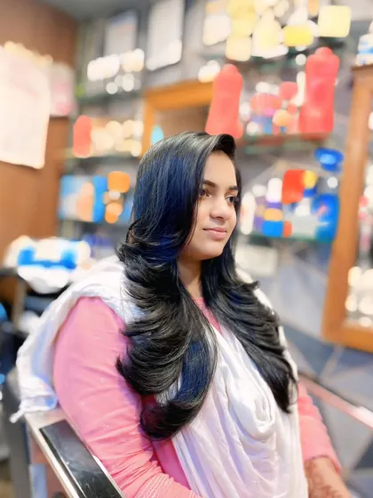 A final shot of the long layered haircut, showcasing its full and healthy appearance. This is a popular choice for clients who want a fresh style without losing too much length.
