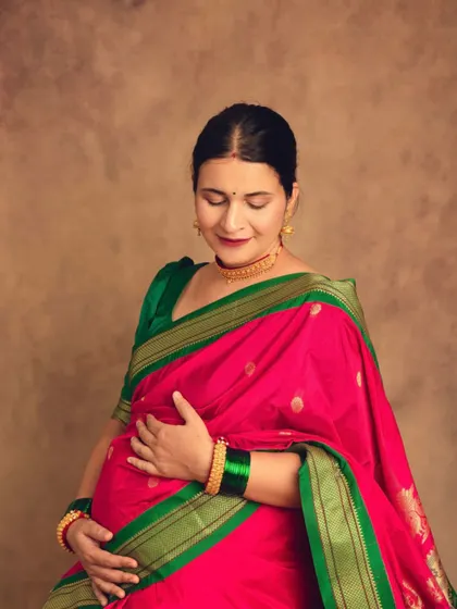 Another beautiful pose from our traditional saree session, capturing the mother's serene glow and the elegance of her attire.