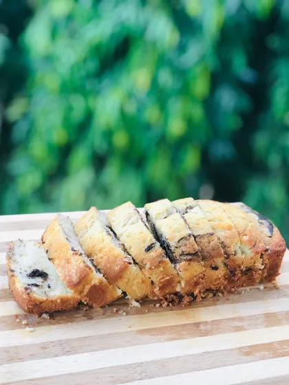 A simple and elegant marble loaf cake, sliced to show the beautiful vanilla and chocolate swirl inside. It's a classic teacake that's always a crowd-pleaser.