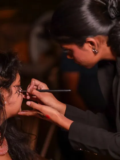 A close-up of the spooky makeup application process at our Halloween event.