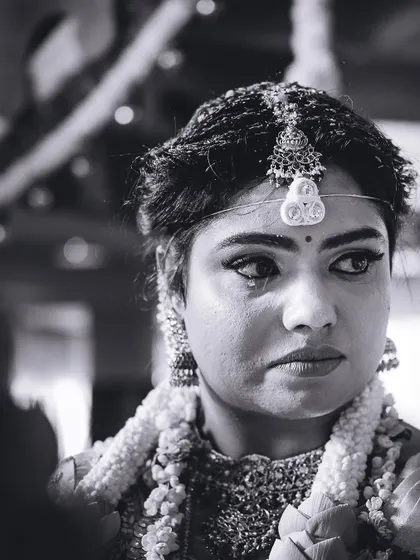 An intimate, emotional black and white portrait of the bride, capturing a moment of deep feeling during the ceremony.