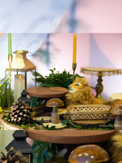 A plush lion rests on a wooden stand amidst rustic mushrooms and lanterns, creating a cozy and wild vignette within the larger Lion King theme.