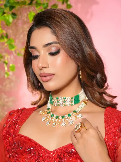 Main character energy for the sister of the groom. This soft glam look in red is powerful yet elegant, with a focus on winged liner and a flawless complexion.