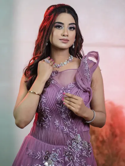 A close-up on the intricate beadwork and structured shoulder detail of the onion pink gown. Every detail is crafted to make you feel special.