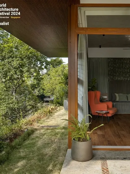 A glimpse from the garden into one of the private rooms, showing how every space in the house is designed to have a visual or physical connection to the outdoors.