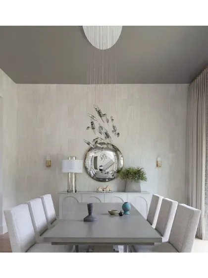 The 'Ox-horn' wallcovering is a masterpiece of texture, created by layering hand-crinkled paper and fabric sheers. The result is a beautifully textured, luminous surface that elevates this dining room.