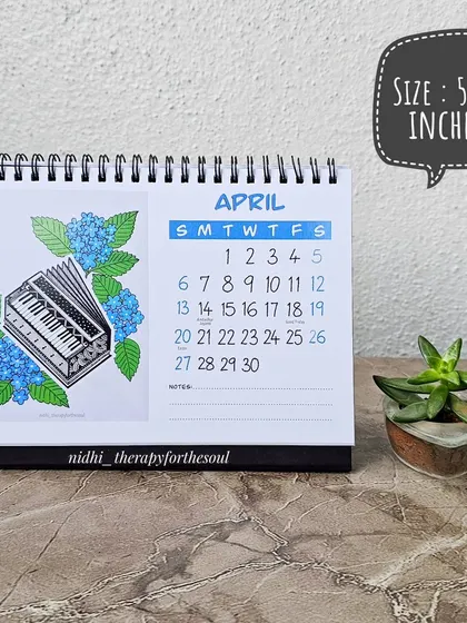 The April page, with a harmonium and blue hydrangeas. The calendar measures 5x7 inches, a perfect size for your workspace.