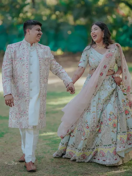 A burst of laughter. This candid shot captures a moment of pure joy and connection between the couple as they walk hand in hand.