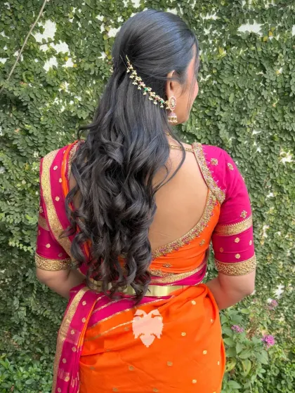 The back view of the hot pink and orange blouse, showing the elegant deep-U cut.