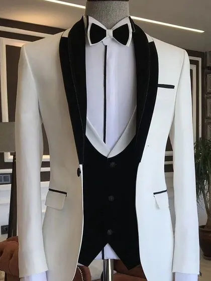 A clean and sharp white tuxedo with a black velvet shawl lapel. This is a timeless choice for any formal event, offering a look of pure sophistication.