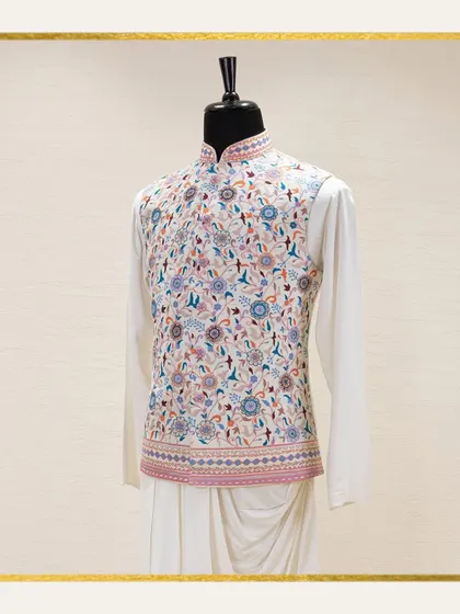 A mannequin displays a white Jawahar jacket with exquisite, multi-colored floral embroidery over a draped kurta. The ethereal beauty of this subtle color palette is ideal for summer functions.