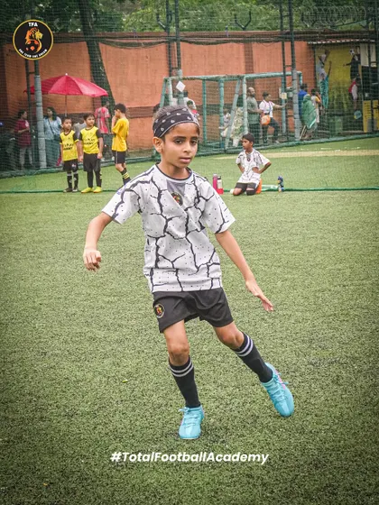 Focus and agility on the field. A young player in mid-motion, ready to take on the opposition.