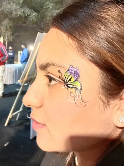 This butterfly design combines yellow and purple with delicate black swirls for a unique and artistic look.