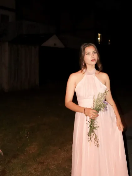 A wide shot creating a storybook feel with the pink Jardinvue dress in the dark.