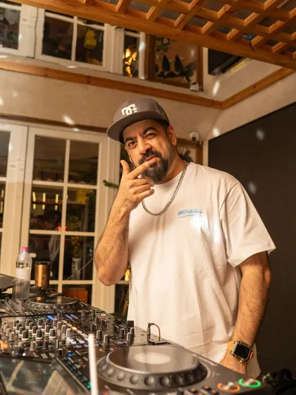 Behind the decks at Monkey Bar, getting ready to take the crowd on a journey through timeless beats and classic vibes.
