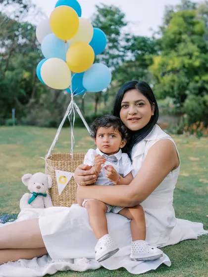 A mother and her son enjoying the outdoors during his first birthday shoot. The connection between them is palpable.