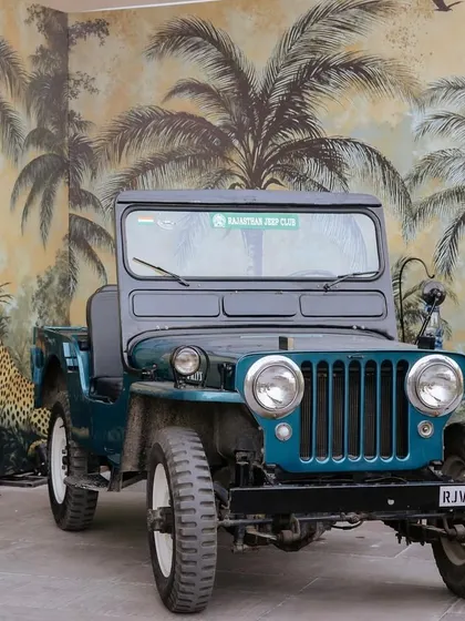 A vintage jeep parked in front of a safari-themed wallpaper created the perfect photo opportunity for guests, adding an element of adventure and fun to the event.