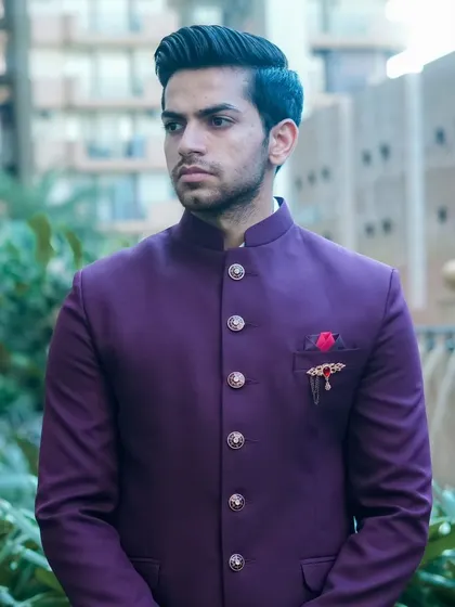 The rich purple color of this Jodhpuri suit looks great outdoors. It's a unique color that will surely get you noticed.