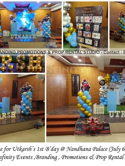 Racing into his first year! This racing theme for a first birthday at Nandhana Palace features a cool blue and gold color palette, car and motorcycle props, and a checkered flag motif for a stylish and speedy celebration.