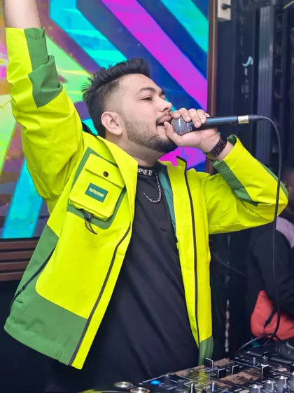On the mic at Havana, hyping up the Bhubaneswar crowd in my signature neon jacket.