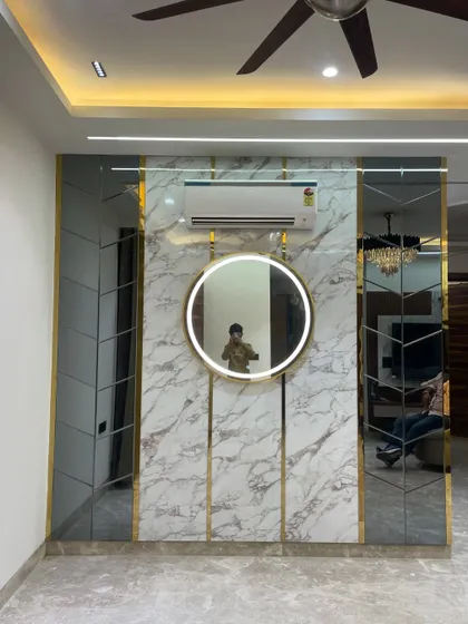 This selfie in the mirror shows the scale and reflective quality of the accent wall. It's a perfect example of how mirrors can make a room feel larger.