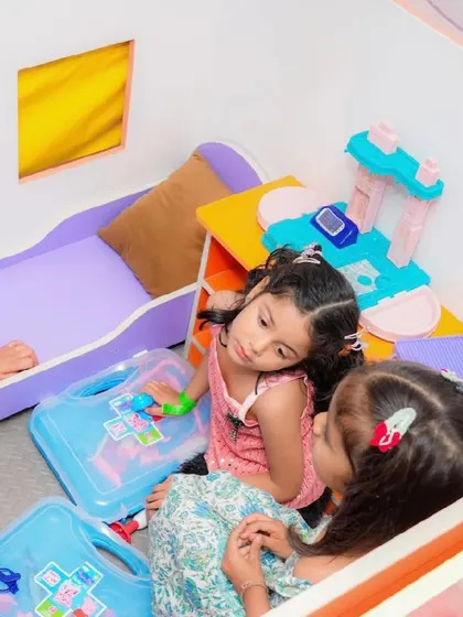 Two girls play with a toy medical kit in our "hospital" themed pretend-play area.