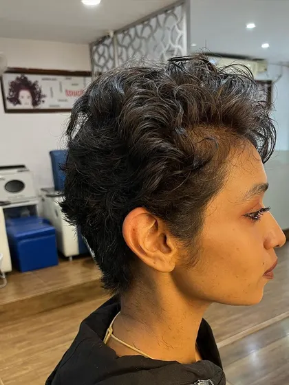 Another side view of the curly pixie, styled with Manetain products for definition.