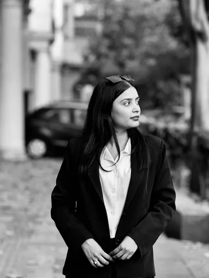 A thoughtful black and white photo. My journey has been about turning obstacles into stepping stones, a resilience I bring to every case.