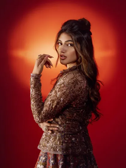A portrait of Sreeleela that emphasizes her expression and the intricate details of the jacket's embroidery.