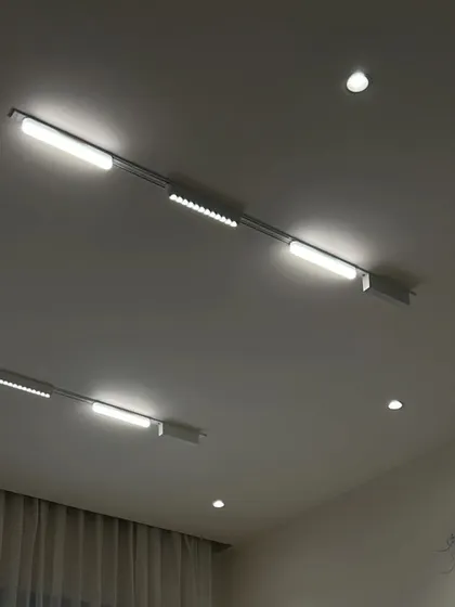 A close-up of a white magnetic track light system with multiple fixtures, providing bright, directional light.