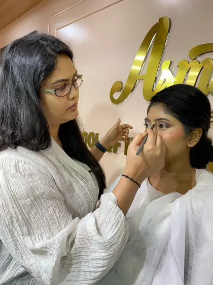 A student from the 16-day pro course practices her eyeliner application. Mastering a steady hand for sharp, clean lines is a skill we focus on extensively.