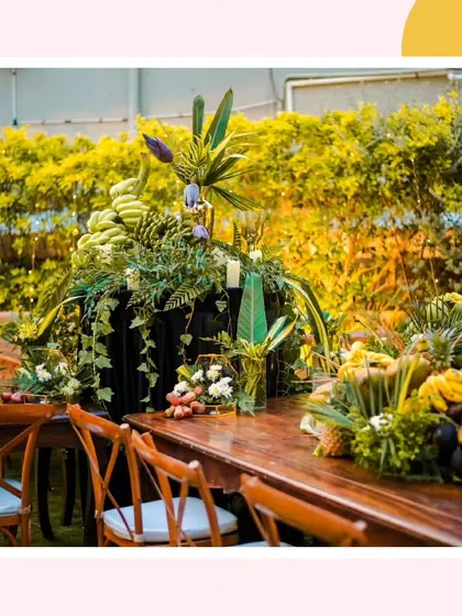 A close-up of the main centerpiece, showing how bunches of green bananas and other produce were used to create a dramatic and abundant focal point.