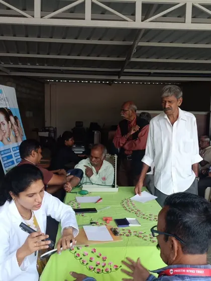 Listening carefully to a patient's concerns at the community health camp. Good communication is the first step towards effective treatment.