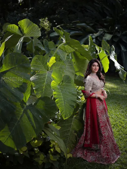 A final wide shot of Mahima in the garden. Her makeup and stunning lehenga create a truly memorable and picturesque image.