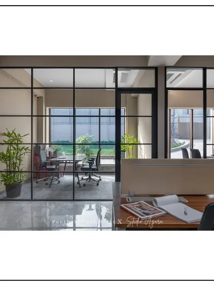 This shot from an employee's perspective shows a clear view into a manager's office, reinforcing the theme of a transparent and non-hierarchical work environment.