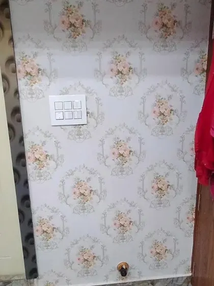 A close-up of a floral medallion wallpaper.