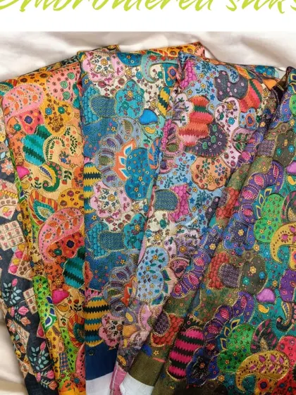A selection of my embroidered and printed silks, showcasing the variety of colors and patterns available for your custom designs.