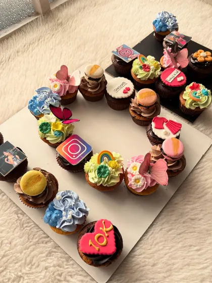 This was a special order to celebrate a friend reaching 10k followers on Instagram. The cupcakes feature a mix of edible photos, logos, and celebratory messages.